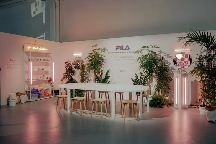 Workshop booth with plants, table, and FILA branding at White Street Market