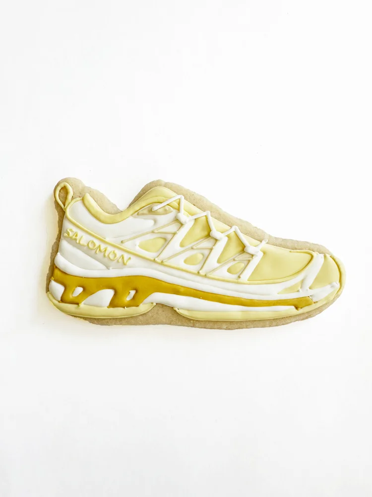 Iced cookie shaped like a Salomon running shoe, baked in New York