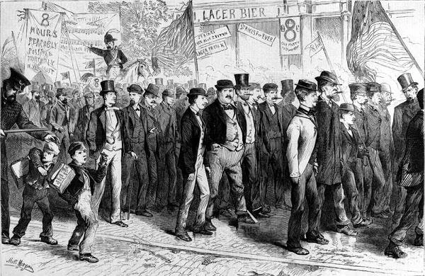 A black and white illustration of a historical scene showing a crowd of men, mostly wearing suits and top hats, walking in a march or parade. Some children are also present. Banners and signs with slogans and advertisements are visible in the background, along with trees and structures.