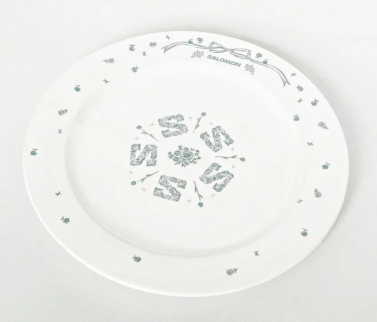 Ceramic plate with printed floral decals, LOVE and 2024 motifs, and Salomon logo