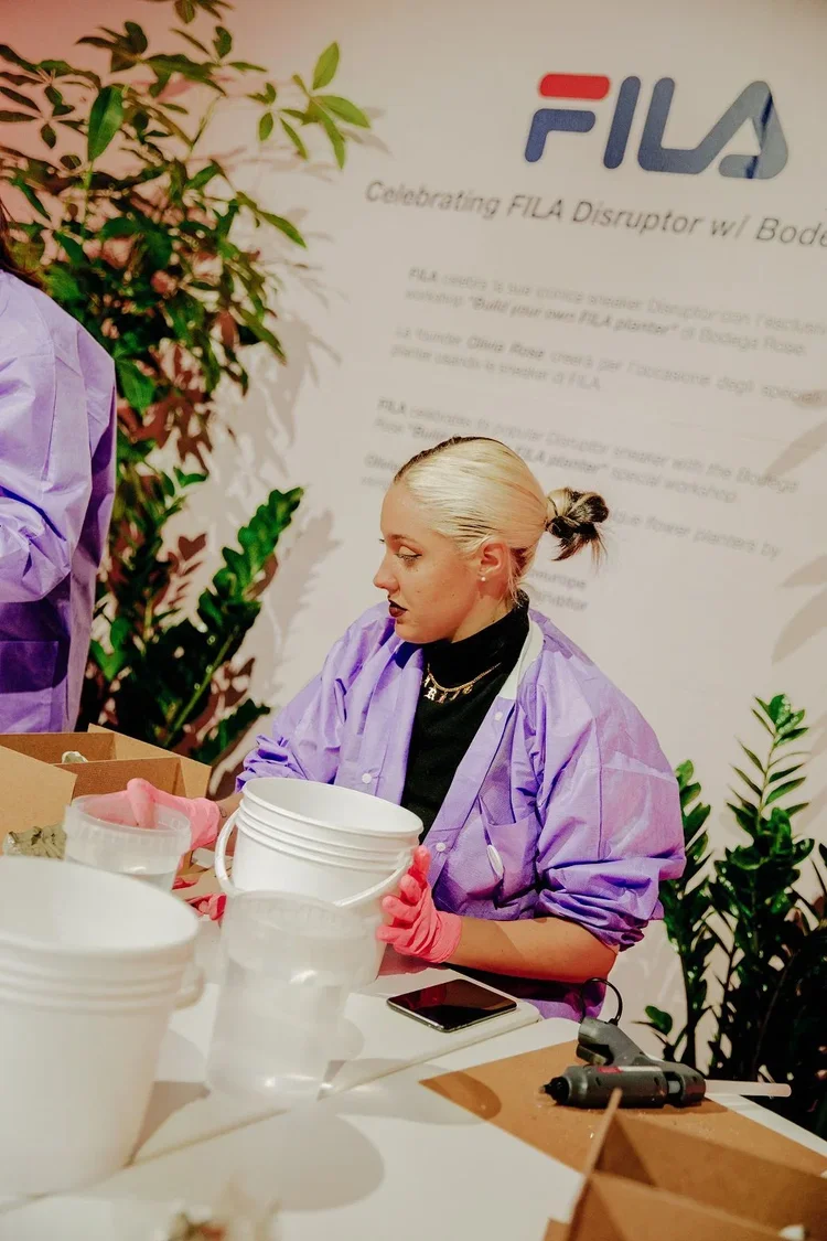 Participant working at the table in a purple workshop gown