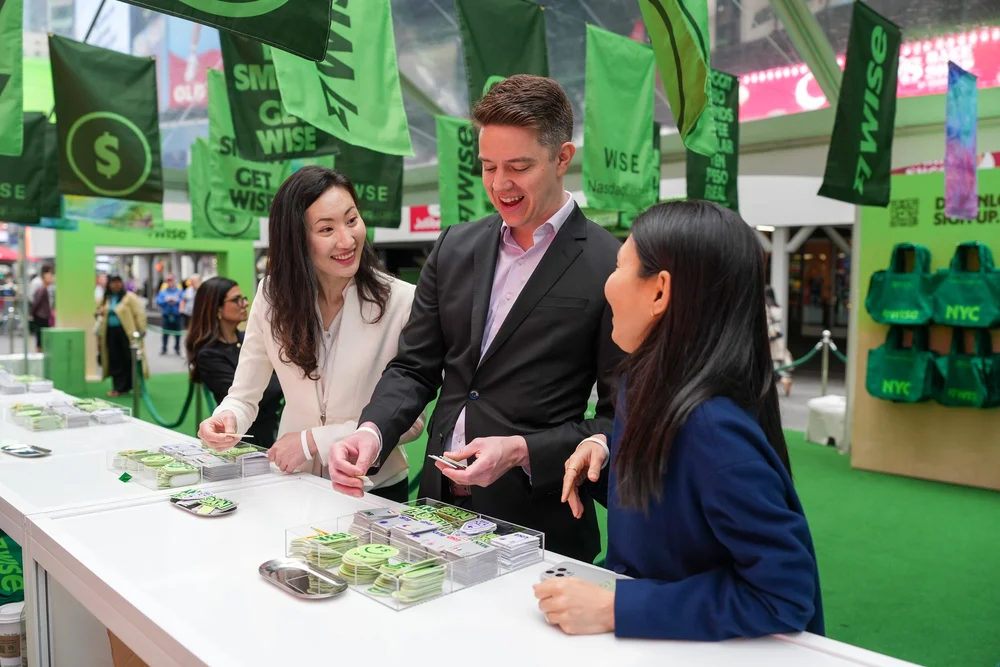 Guest choosing currency patches at the Wise IPO heat press bar