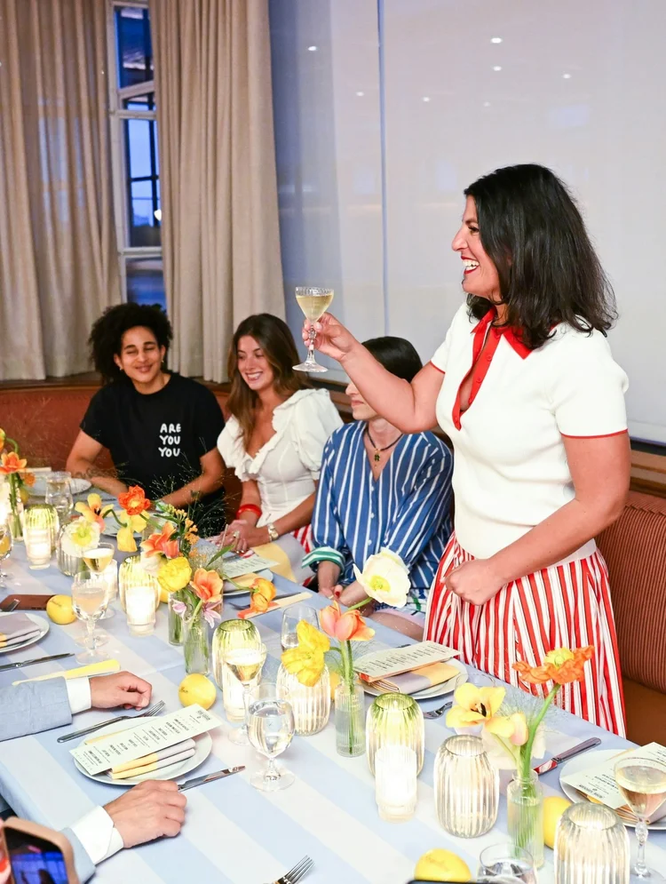 Guests toasting at the Rosie Assoulin x Target launch dinner