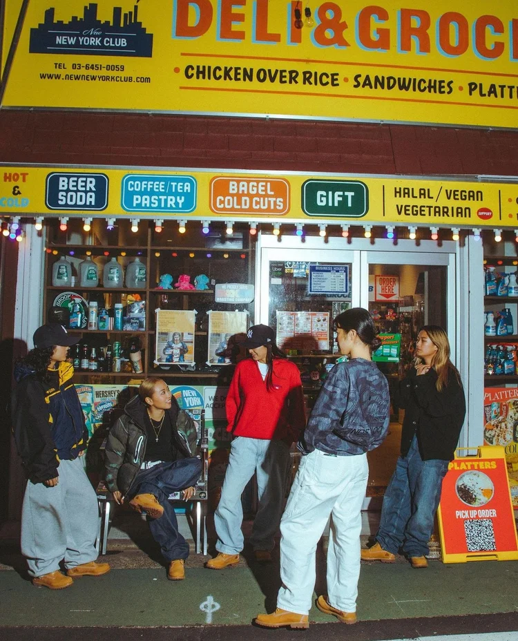 Group outside a convenience store at night during the Tokyo campaign shoot