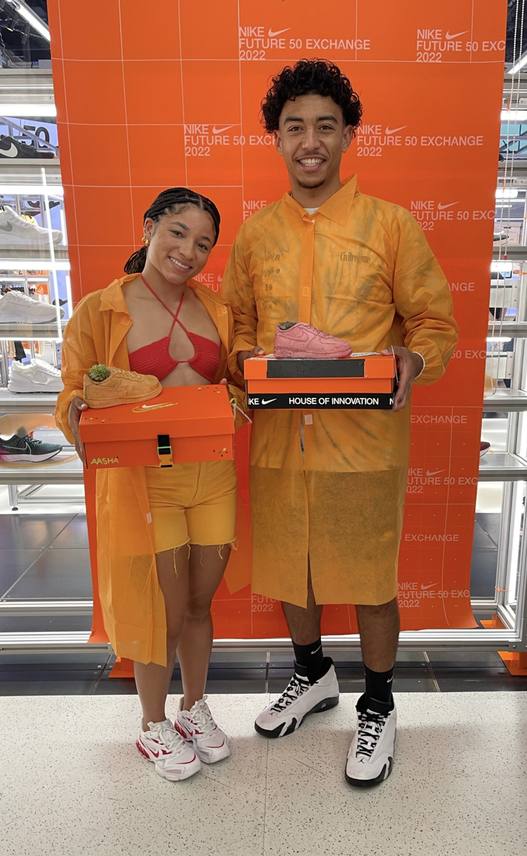 Guests holding shoeboxes with their finished pieces