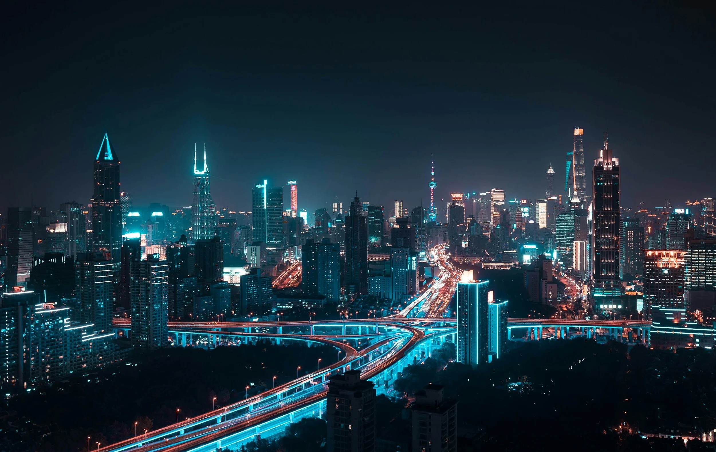 Night city skyline with illuminated skyscrapers and highways with light trails, mystery shopper, saas software, tech companies, competitor analysis