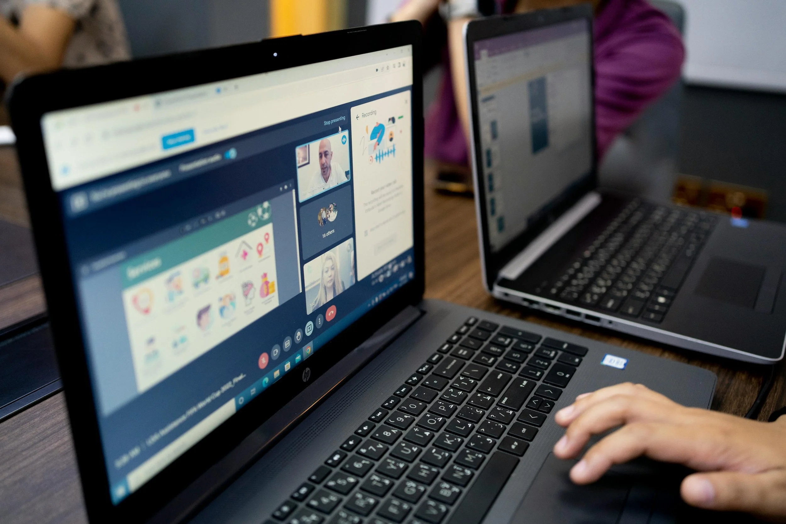 Mystery shopper using a laptop to conduct a competitor analysis for a SaaS company via video call, showing multiple participants
