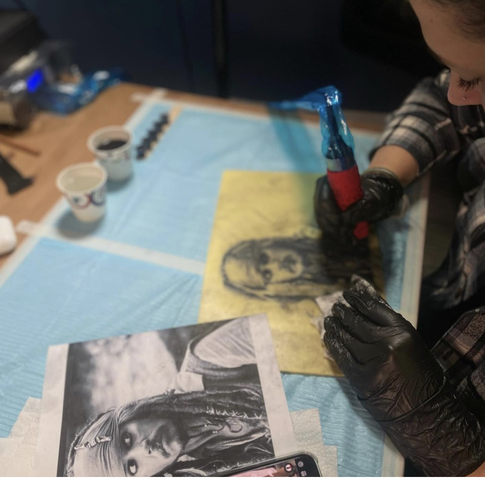 Tattoo students learning in a professional on-campus tattoo studio environment at Master Tattoo Institute