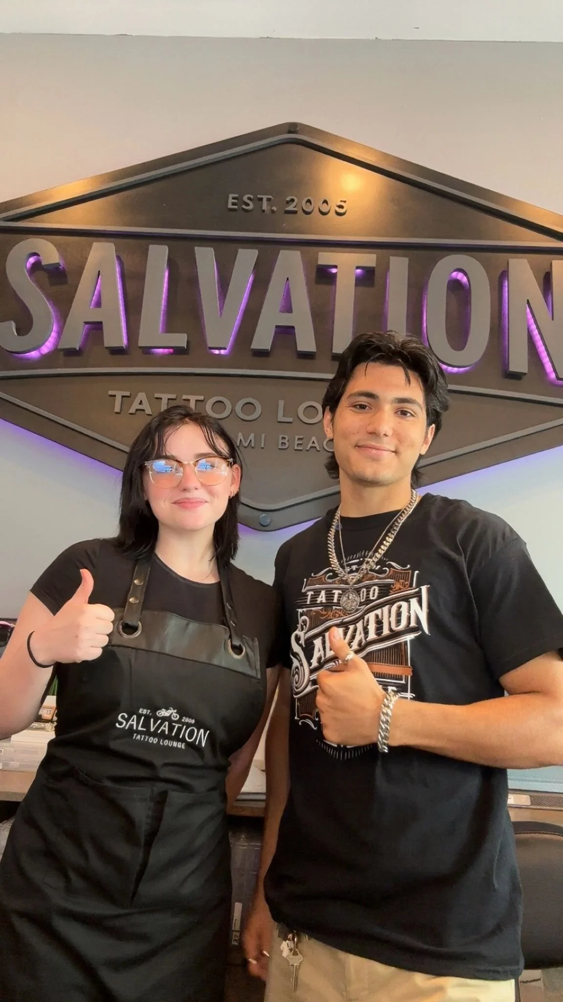 Students from a professional tattoo school gaining hands-on experience in a tattoo studio"
