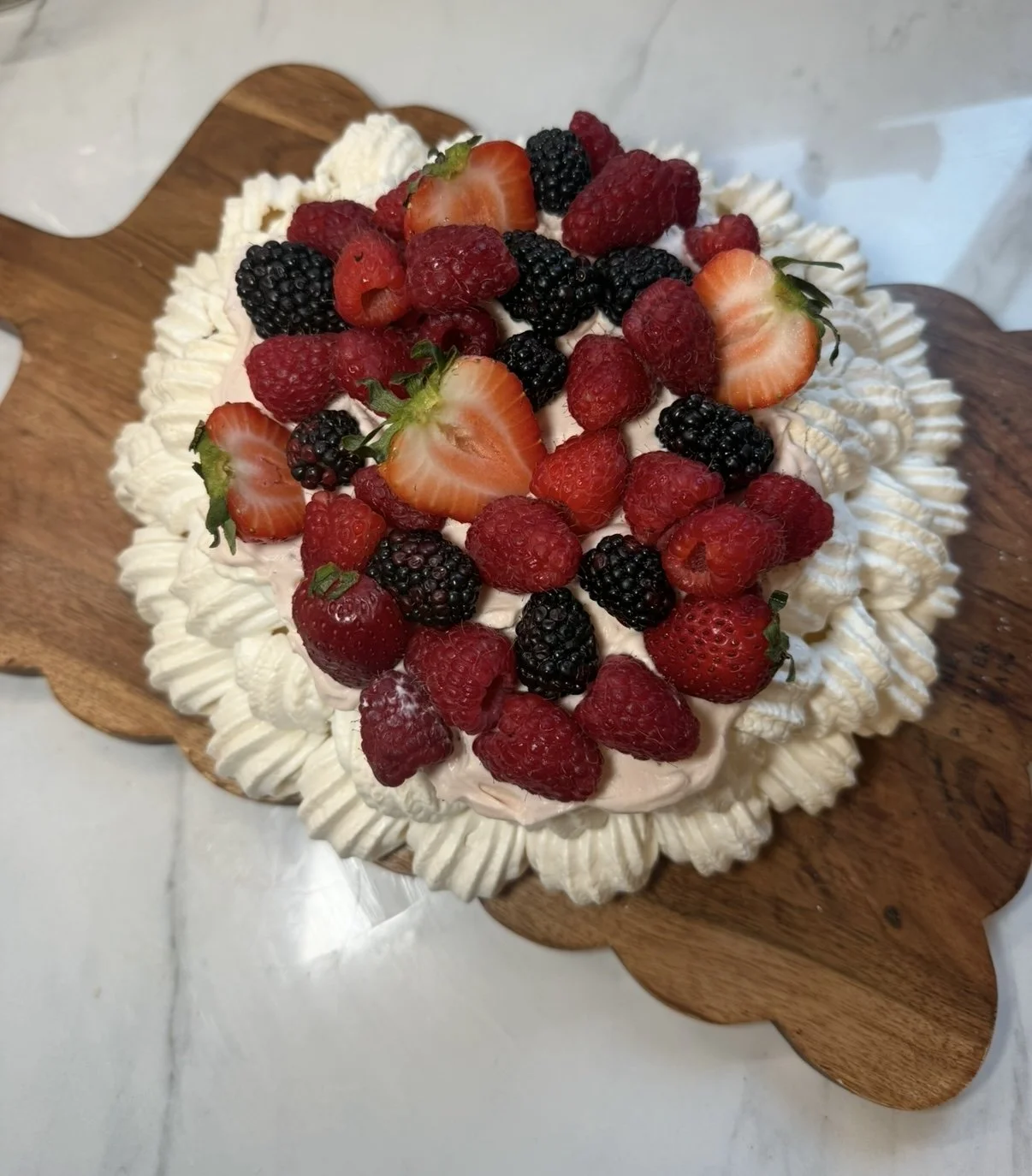 Pavlova Cake with Berry Tea-Infused Whipped Cream