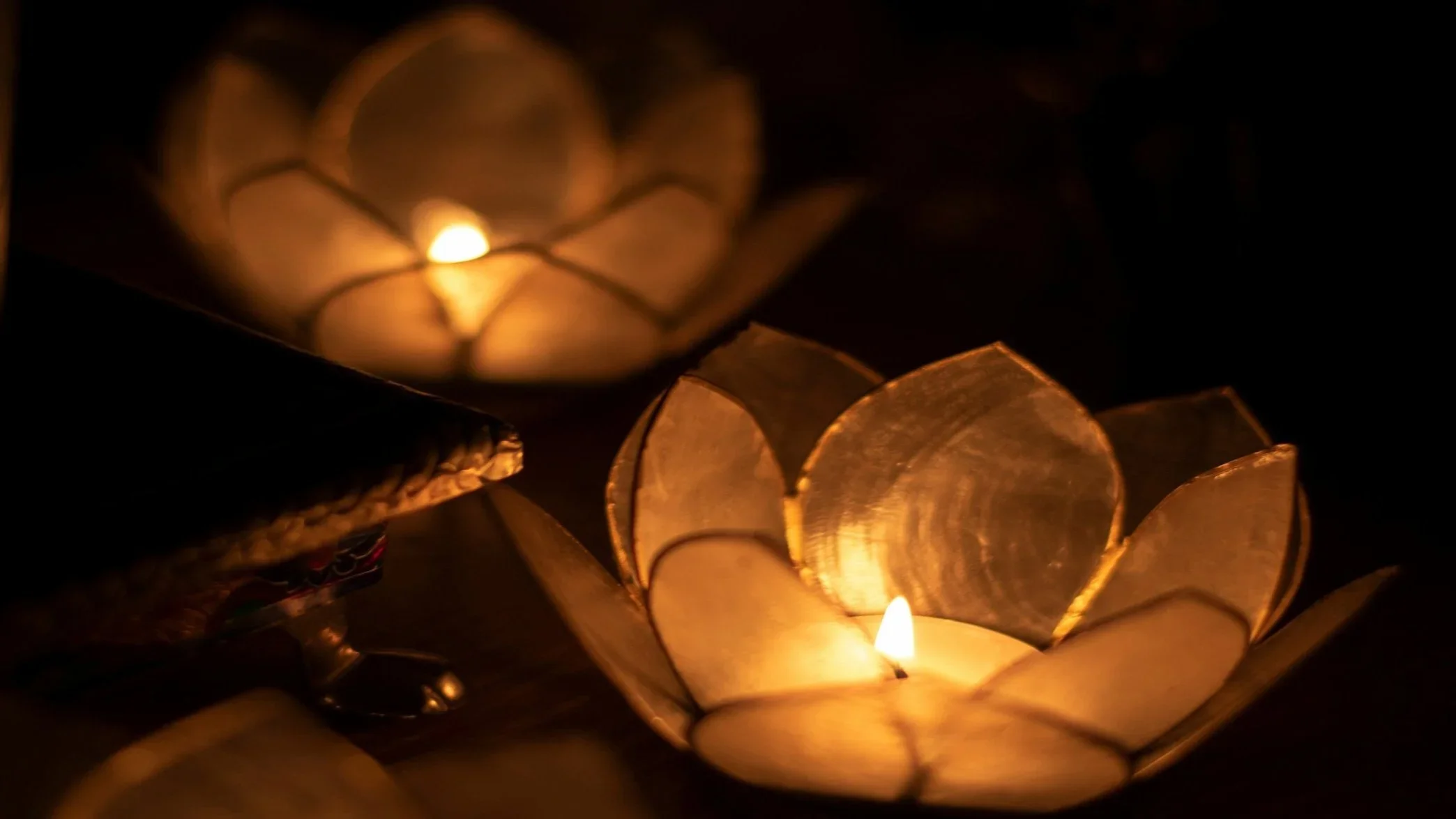 Warm candlelight representing the sacred feminine element of fire
