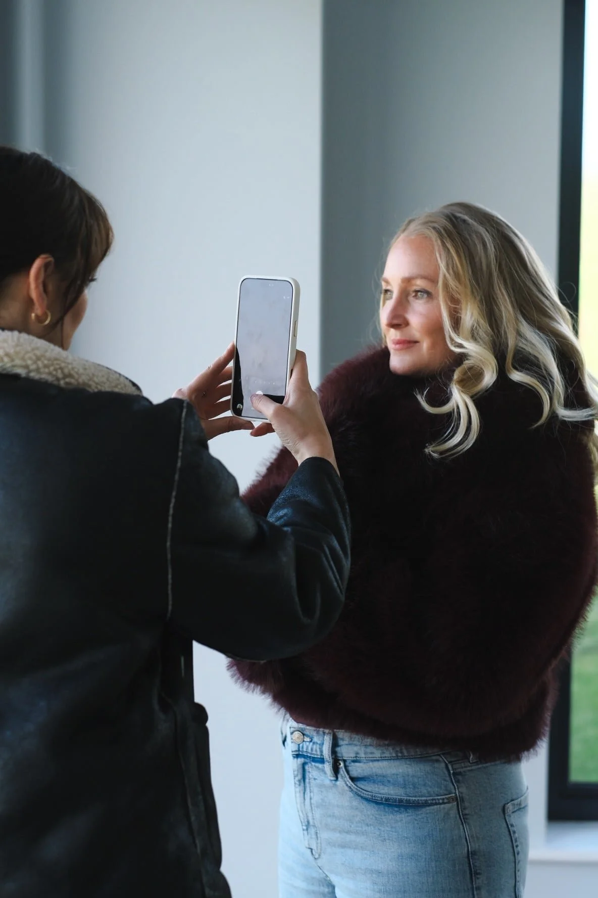 Woman having her photo taken, representing visibility, confidence and feminine leadership for high-achieving women in business