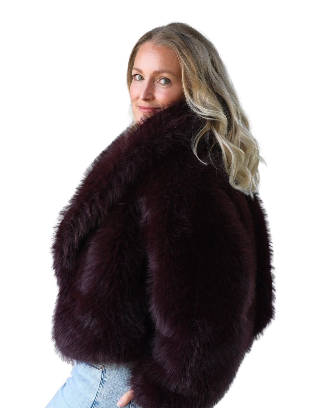 Confident woman in statement coat and jeans, representing empowered feminine leadership, identity and self-expression for high-achieving women