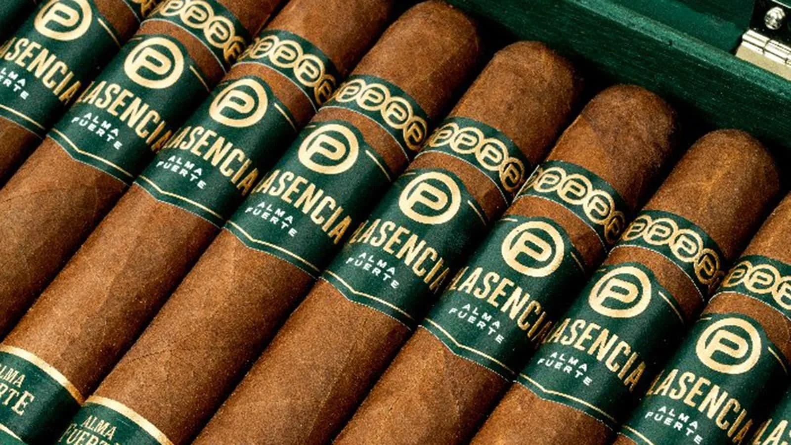 Multiple cigars with green and gold labels that read "Lasencia" and "Alma Fuerte" arranged in a row.