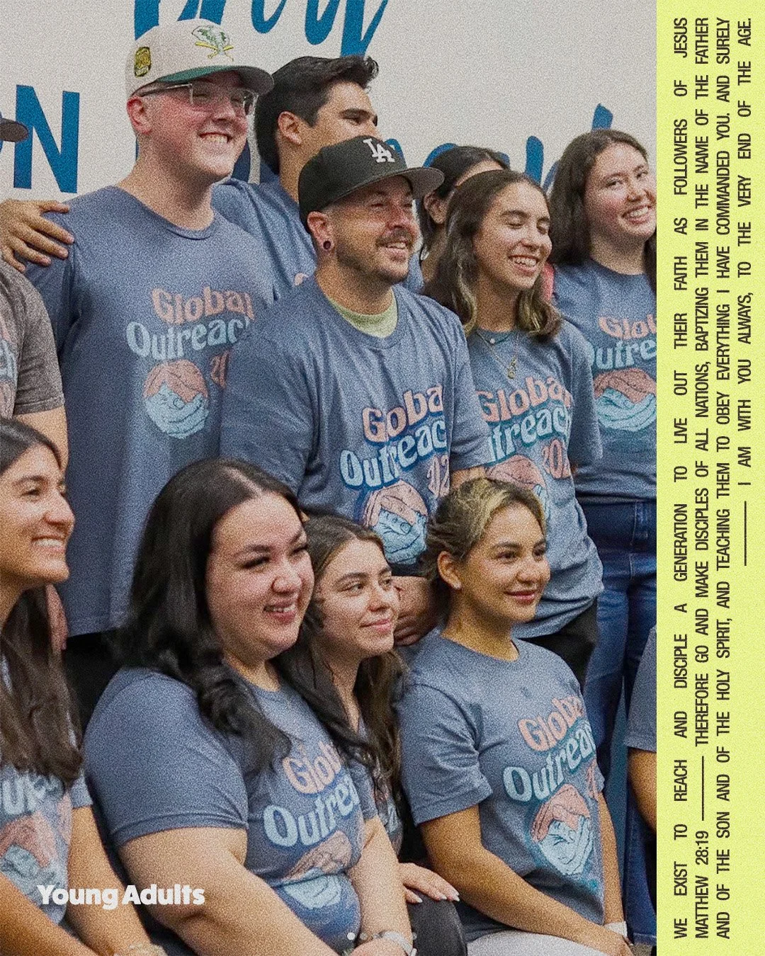 Group of young adults wearing blue t-shirts with 'Global Outreach' printed on them, smiling and standing together at an event