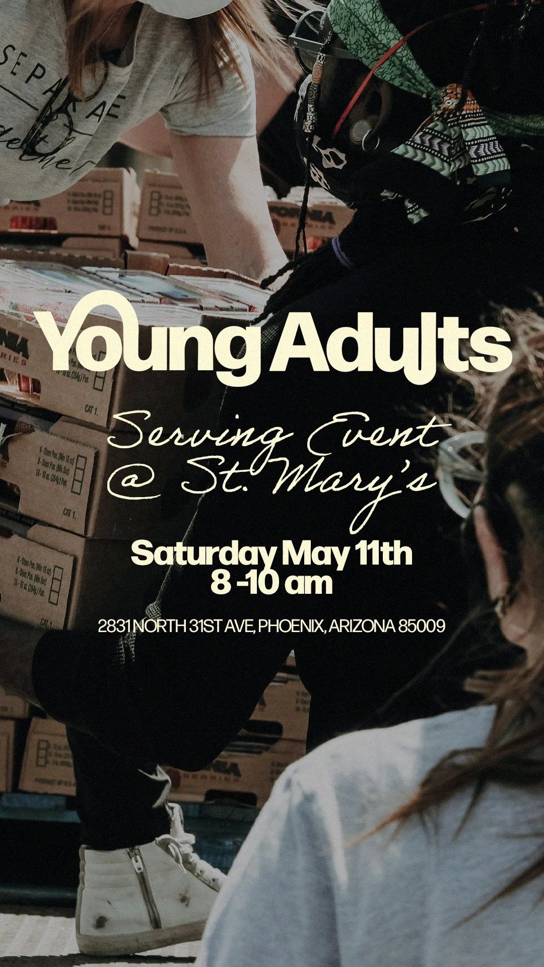 Young adults volunteering at a food distribution event, stacking boxes of supplies in a warehouse.