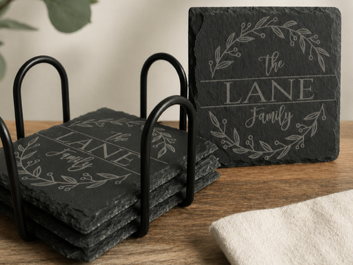 Personalized black slate coasters with custom laser-engraved designs and coaster holder.