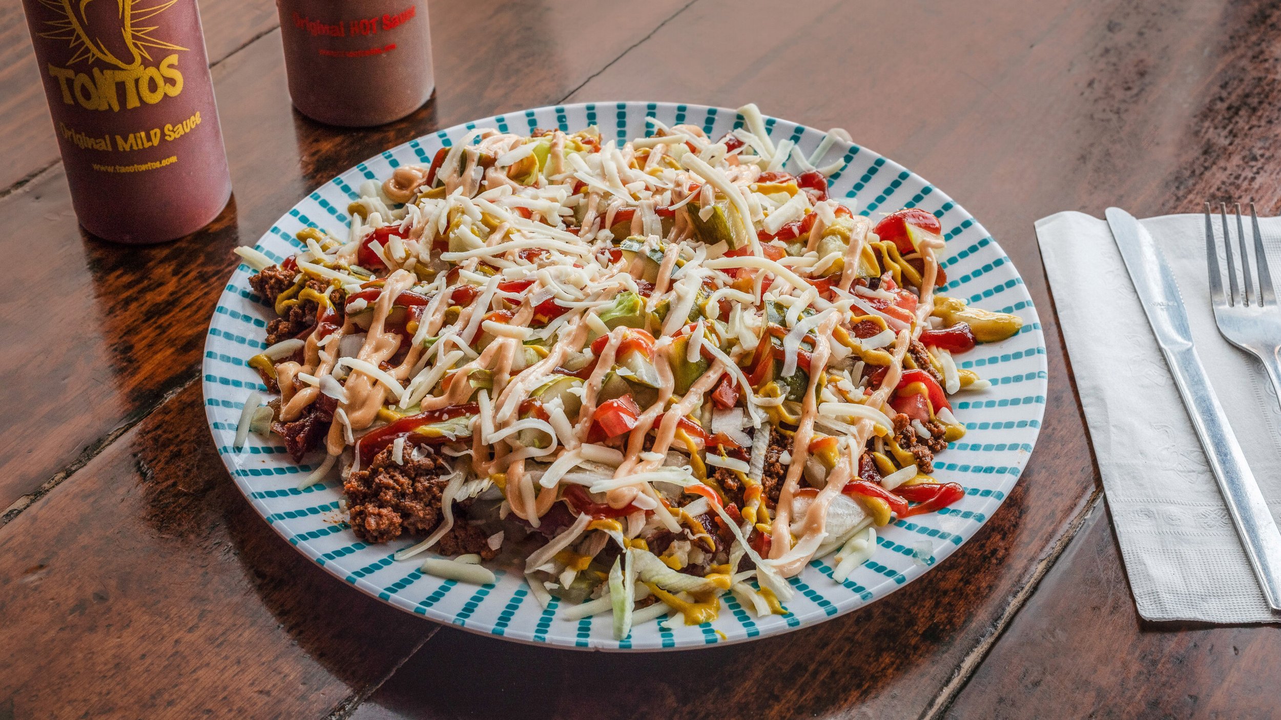 Look! It's a bird, it's a plane, it's a Cheeseburgerito bowl! Potatoes, lettuce, tomatoes, cheese, sour cream, yellow mustard, ketchup, dill pickles, and delicious seasoned beef