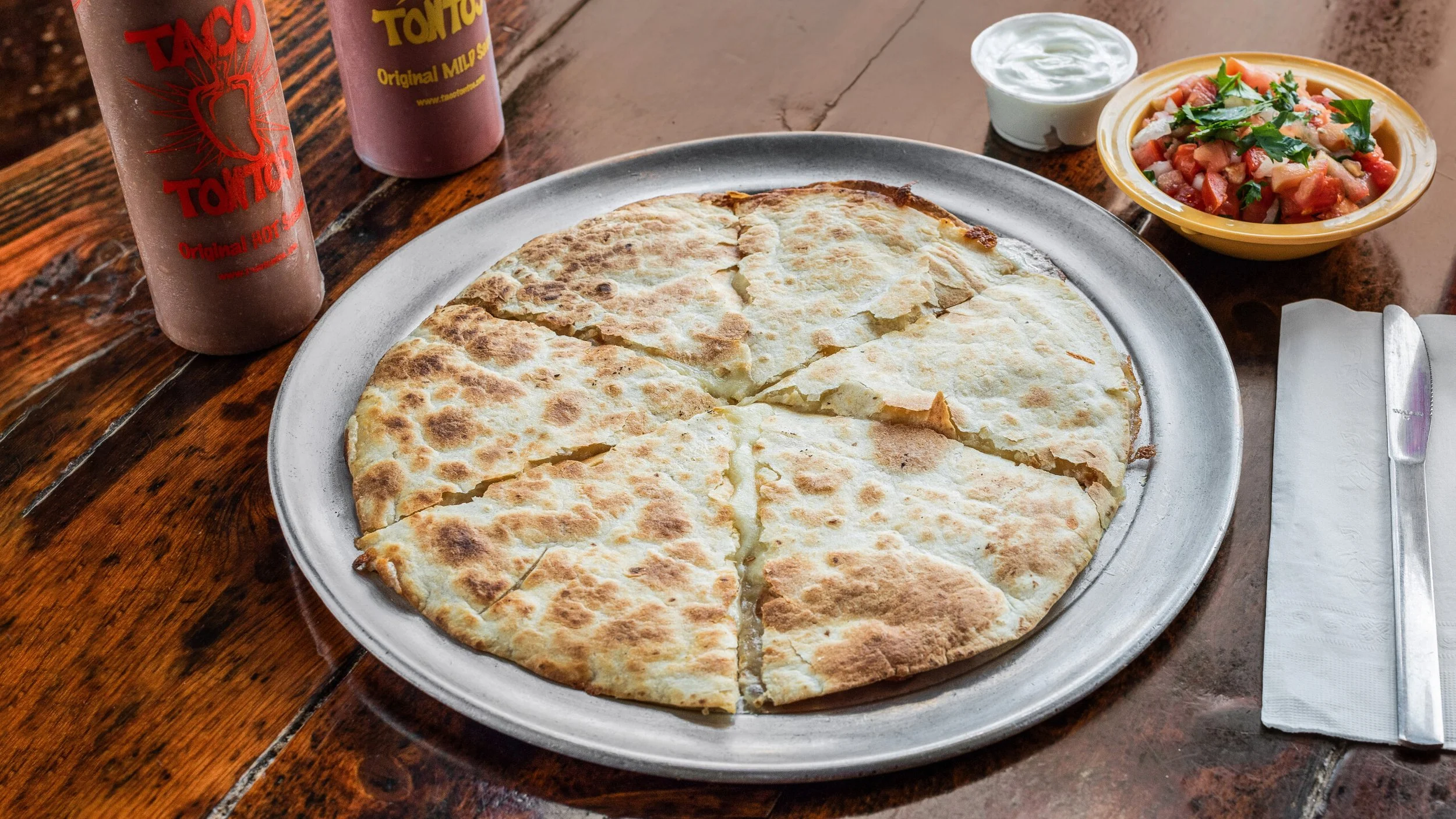 Our quesadillas are oh so cheesy and delicious, especially with our house salsas, pico de gallo, and sour cream.