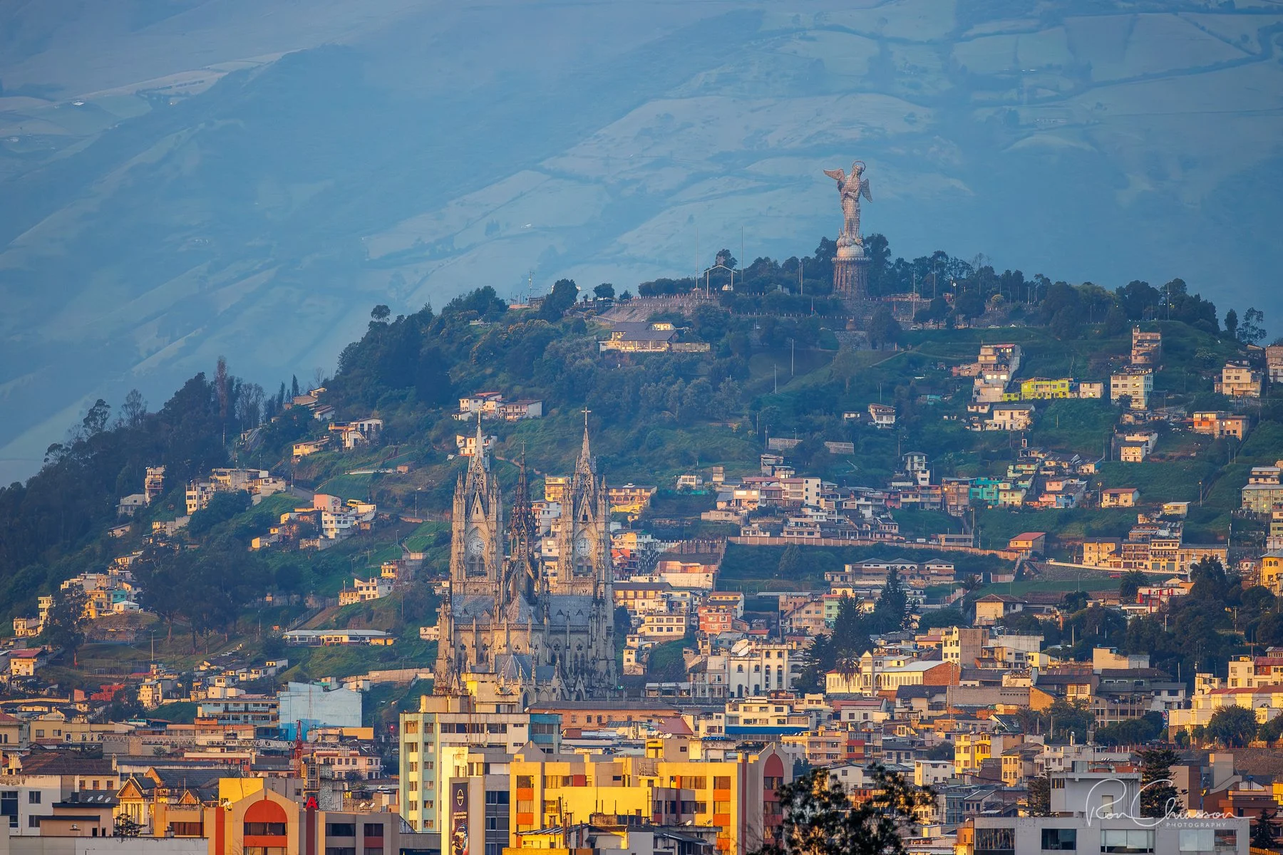 The Basilica, Panecillo and Virgin of Quito bathed in the first light of the day. View from North Quito. ©Ron Chiasson Photography @rsonphoto.