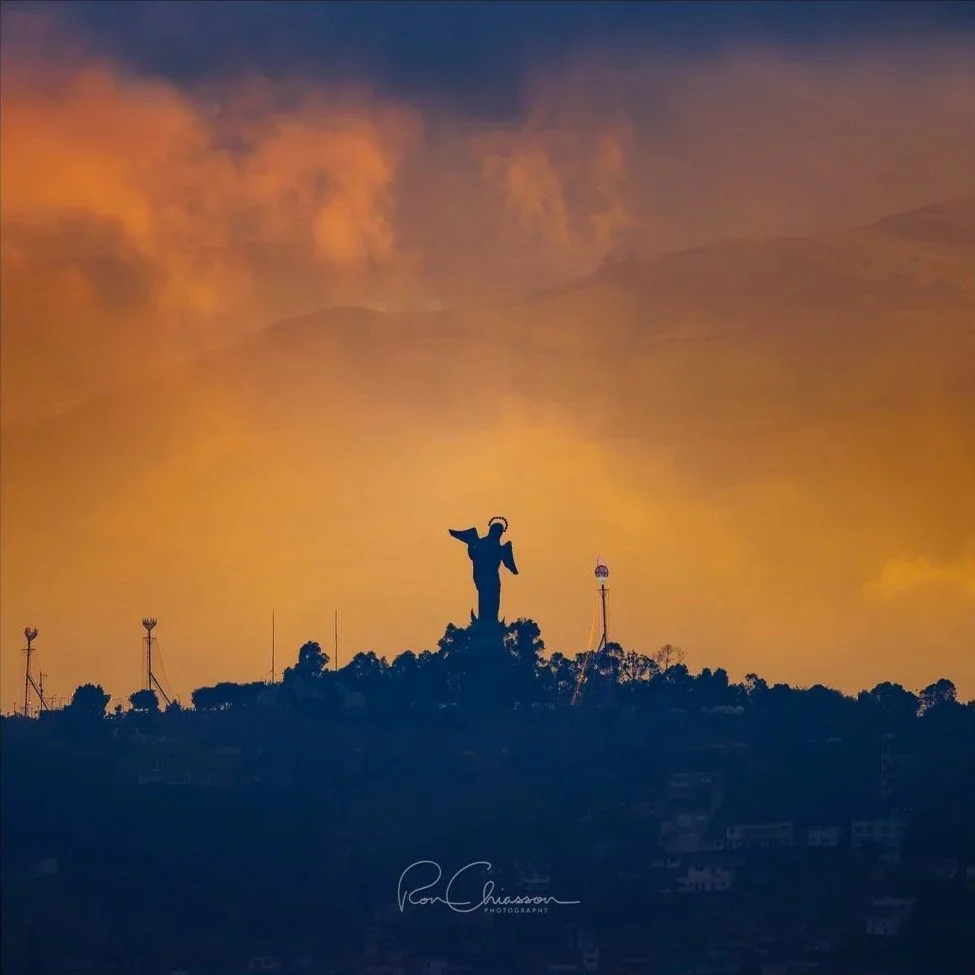 The sky is ablaze with the late day sun and the oncoming storm behind the silhouetted Virgin of Quito. ©Ron Chiasson Photography @rsonphoto.