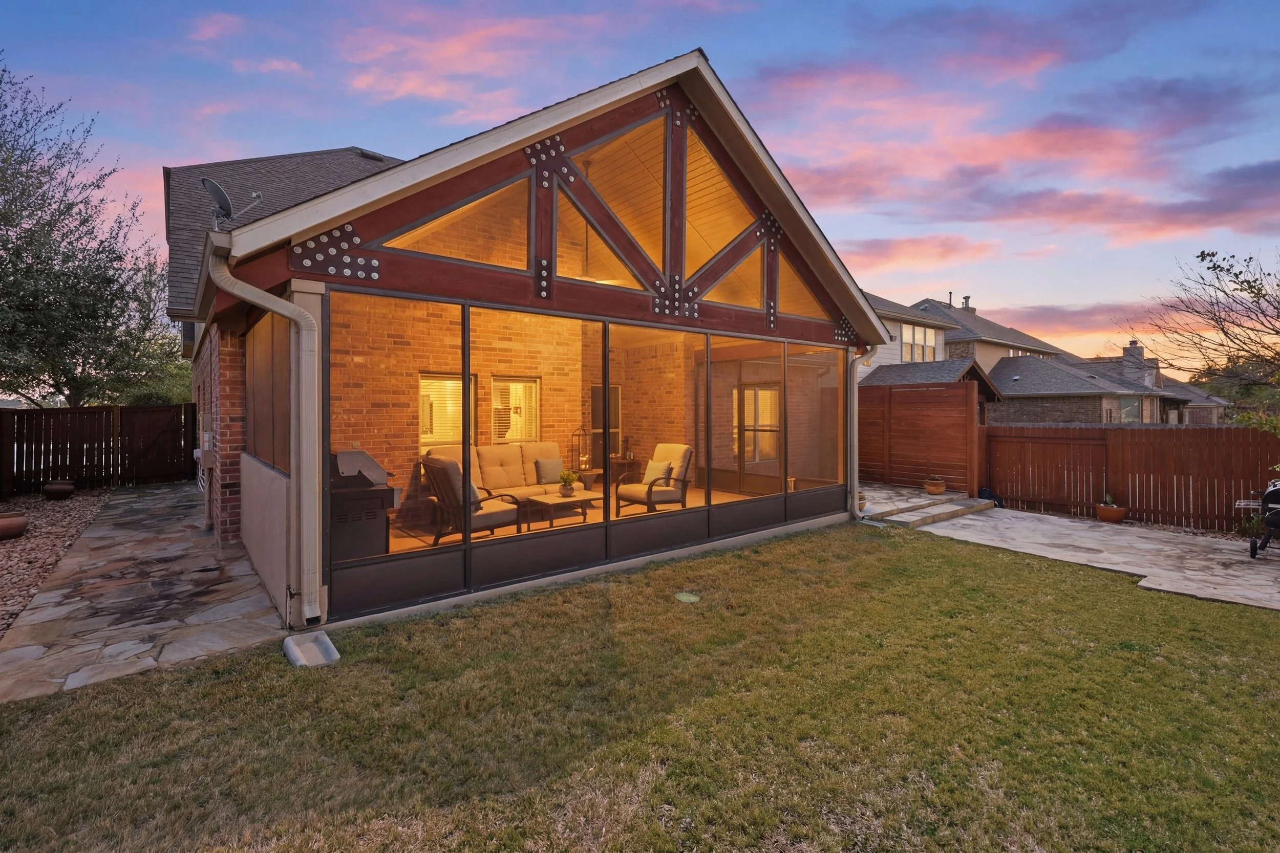 Twilight Exterior- Backyard view with Sunroom glow