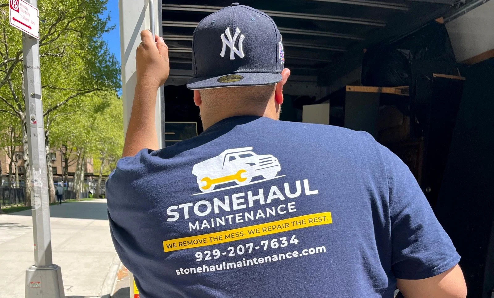 StoneHaul Maintenance crew member loading a junk removal truck in NYC