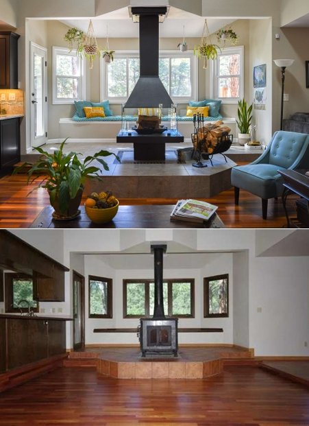 Living room with central fireplace, windows, colorful cushions, and plants, as well as a second room with wood flooring, a wood stove, and multiple windows.