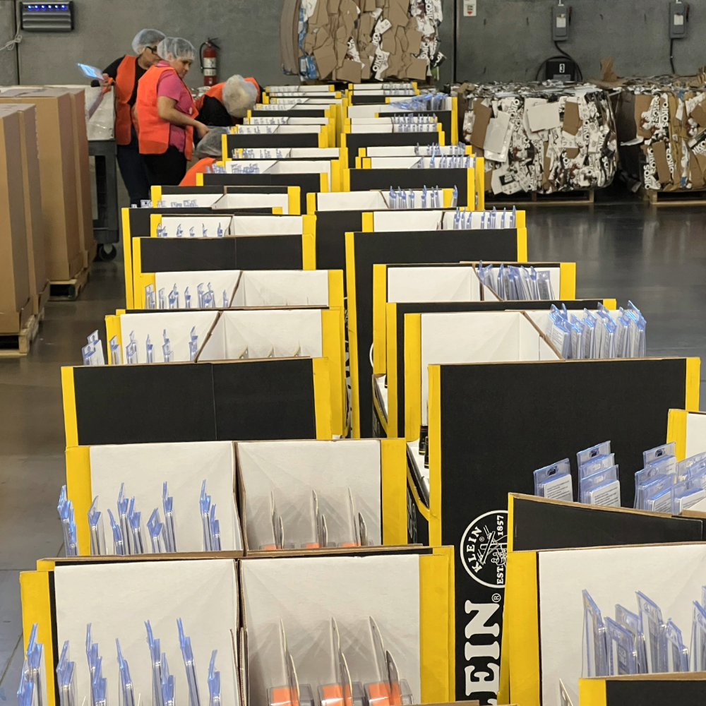 Assembly and pack-out operations preparing POS displays for shipment and rollout.