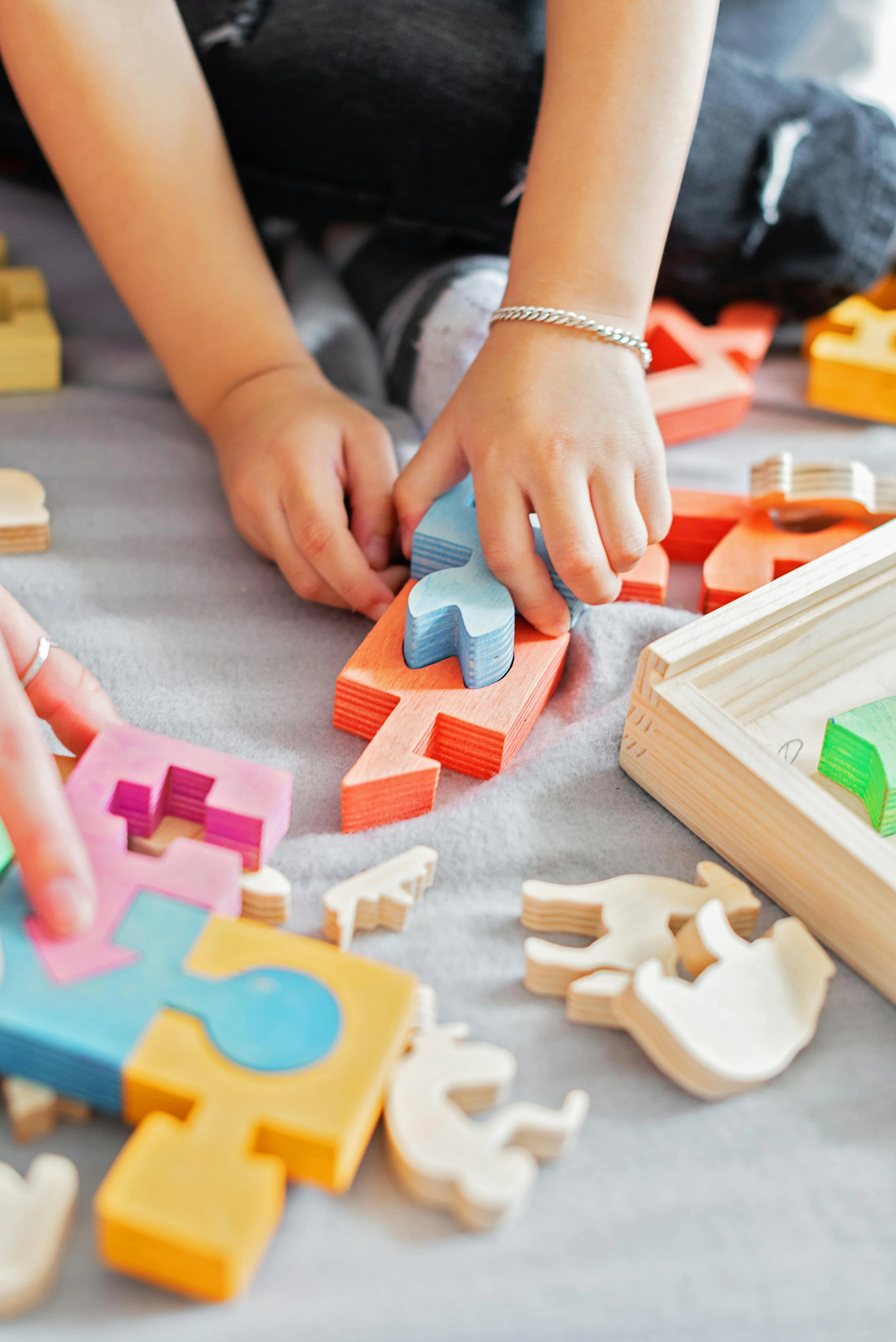 A young child playing with building blocks in a therapy session