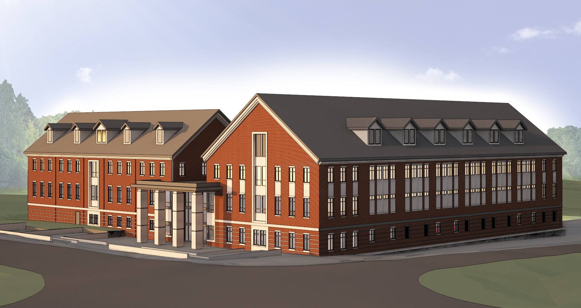 A large red brick building with multiple floors, gray roof with dormer windows, and a central entrance with four white columns.