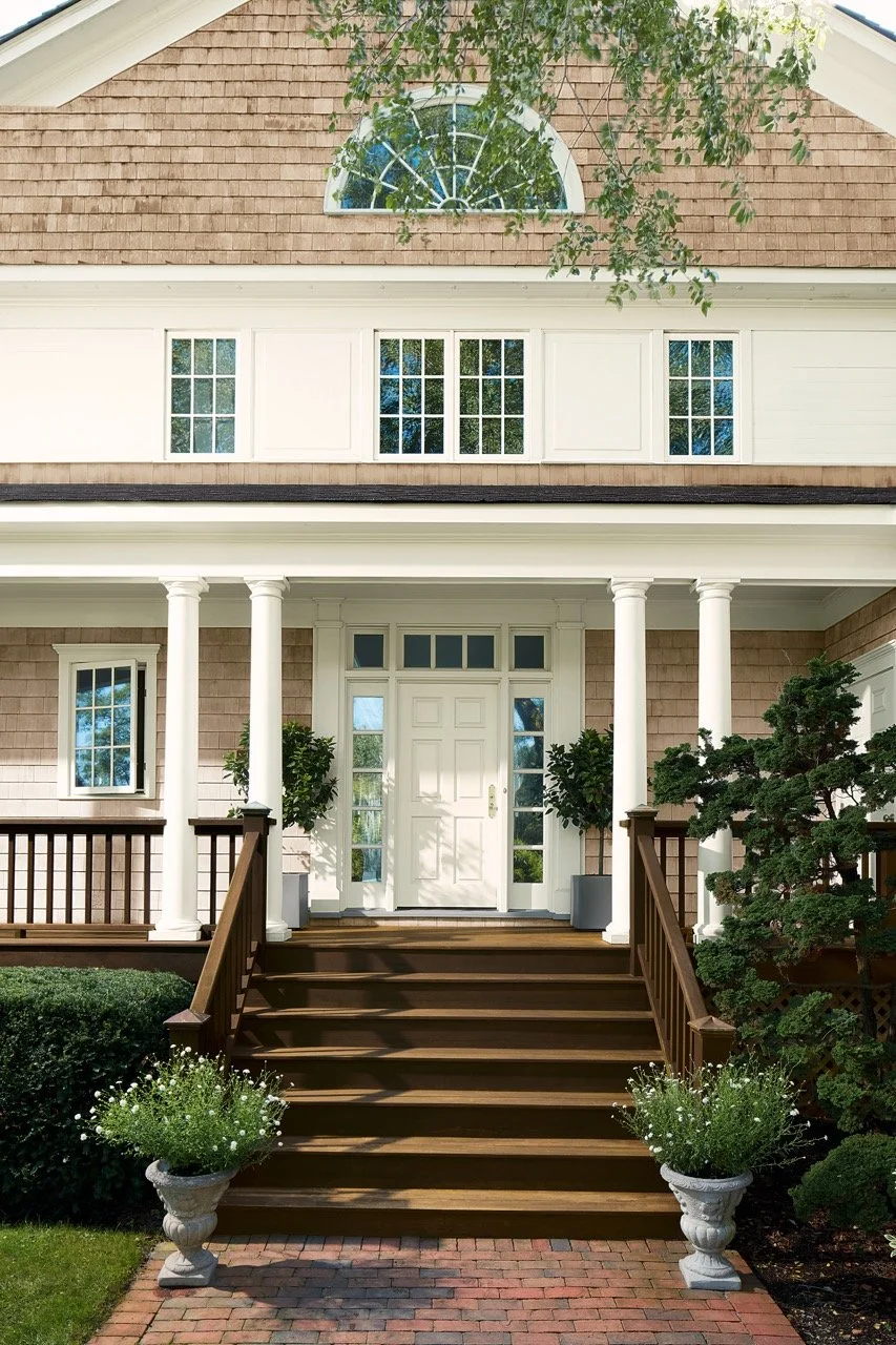 Benjamin Moore exterior white and brown paint on a house with wooden stained stairs