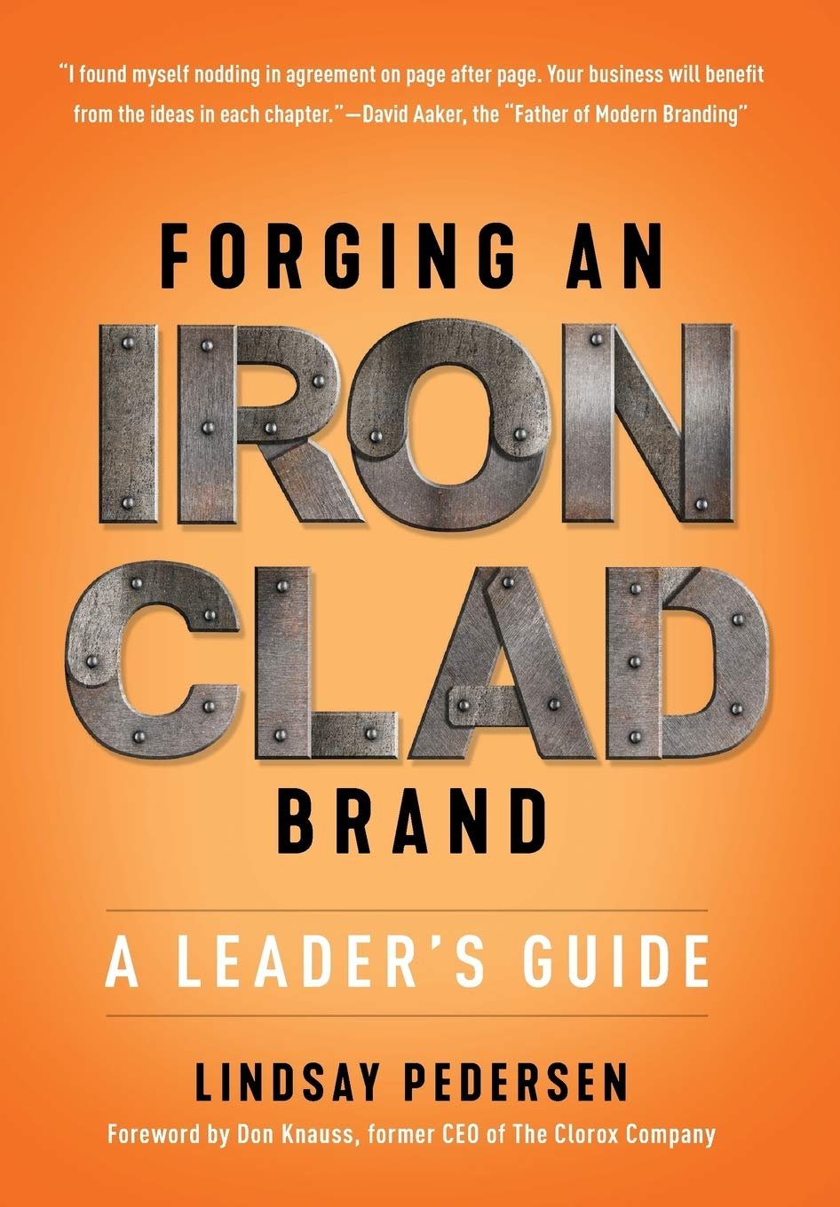 Cover of the book "Forging an Ironclad Brand: A Leader's Guide" by Lindsay Pedersen, featuring bold metallic lettering on an orange background with a quote at the top.