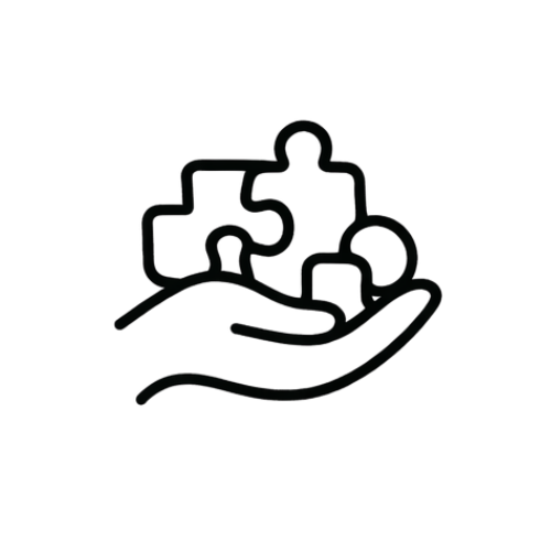 A hand holding four puzzle pieces.