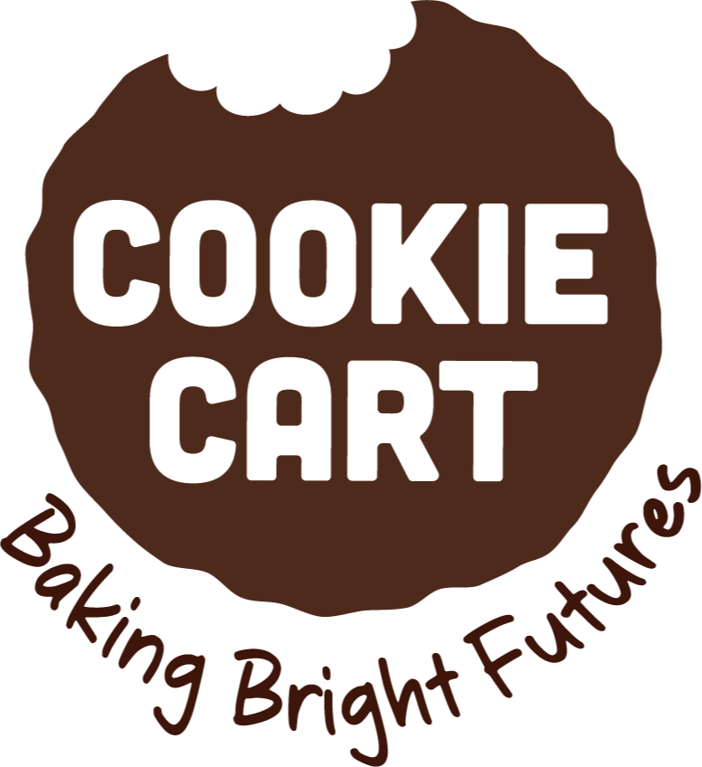 Logo of Cookie Cart with a cookie illustration, saying 'Cookie Cart' in large white letters and 'Baking Bright Futures' in smaller dark brown letters around the edge.