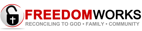 Logo with a black and white medical cross inside a padlock symbol, and the word 'FREEDOM' in large red letters, with the tagline 'Reconciling to God, Family, Community' underneath.