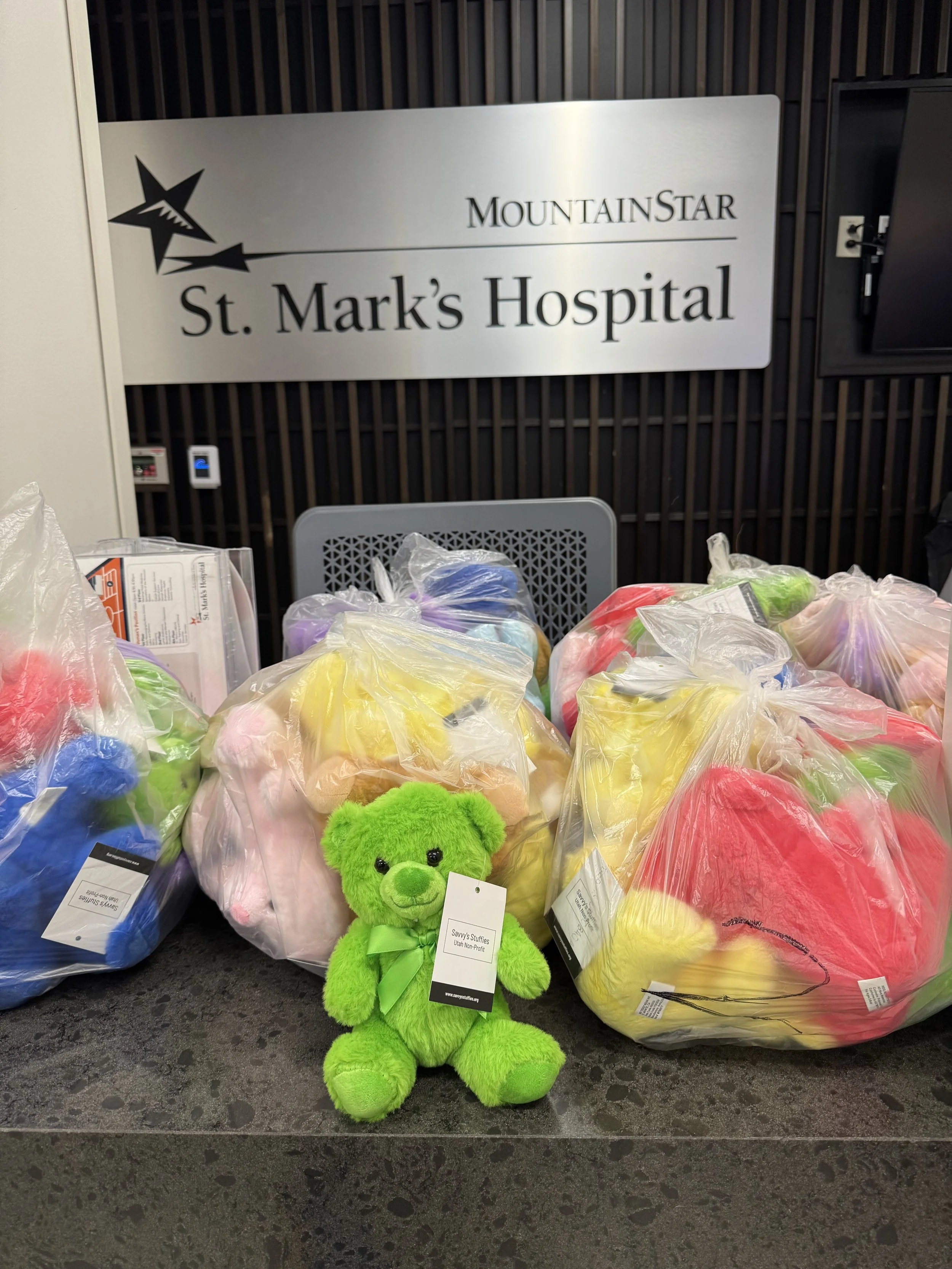 Colorful teddy bears in plastic bags placed on hospital reception desk at St. Mark's Hospital, MountaInStar.