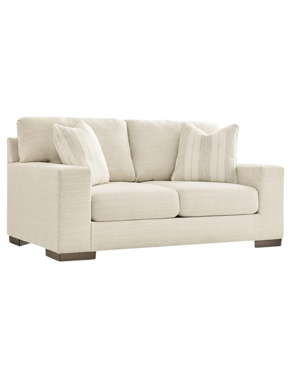 A cream-colored sofa with two matching cushions, set against a plain background.