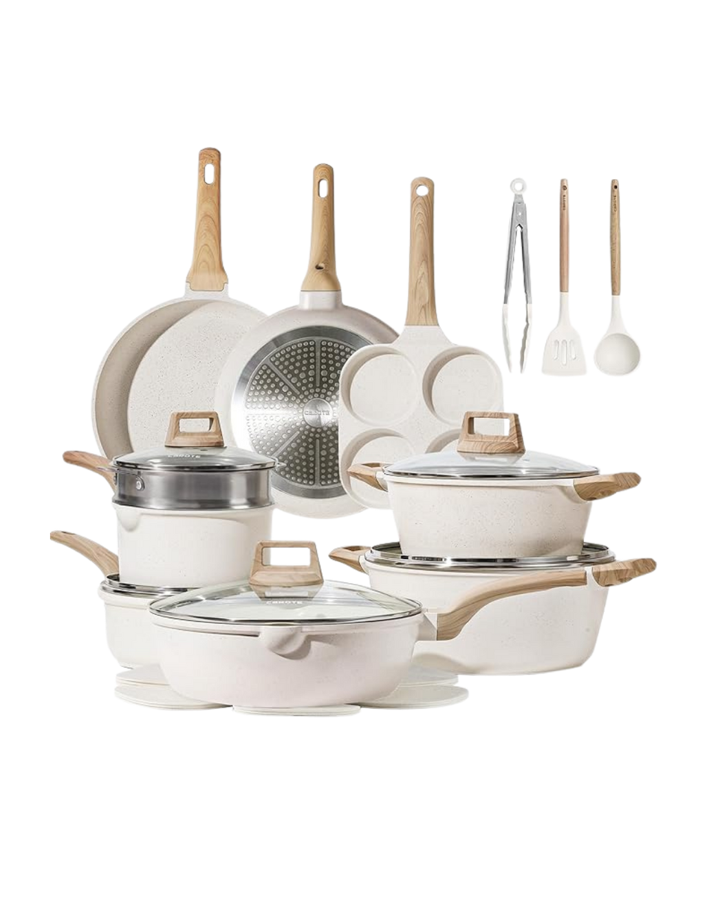 A collection of white and beige ceramic and stainless steel cookware including frying pans, saucepans, pots with lids, and utensils with wooden handles.