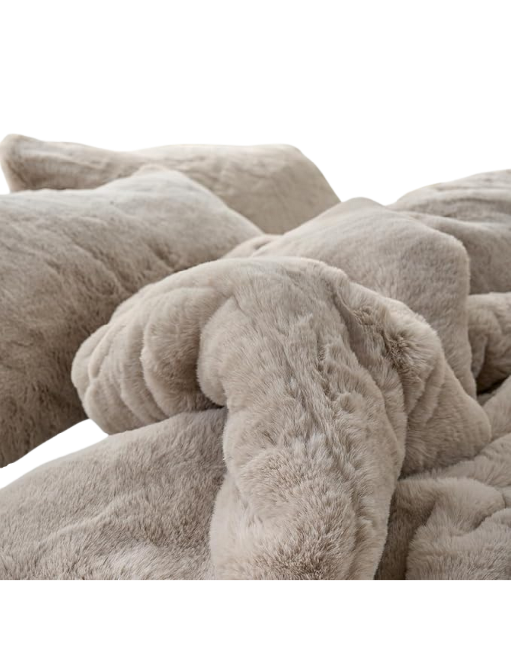 A close-up view of several folded, beige plush blankets piled together.