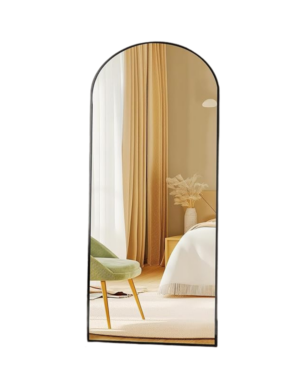 A tall, arched mirror reflecting a bedroom with beige walls, a white bed, a white vase with dried flowers, beige curtains, and a green chair.