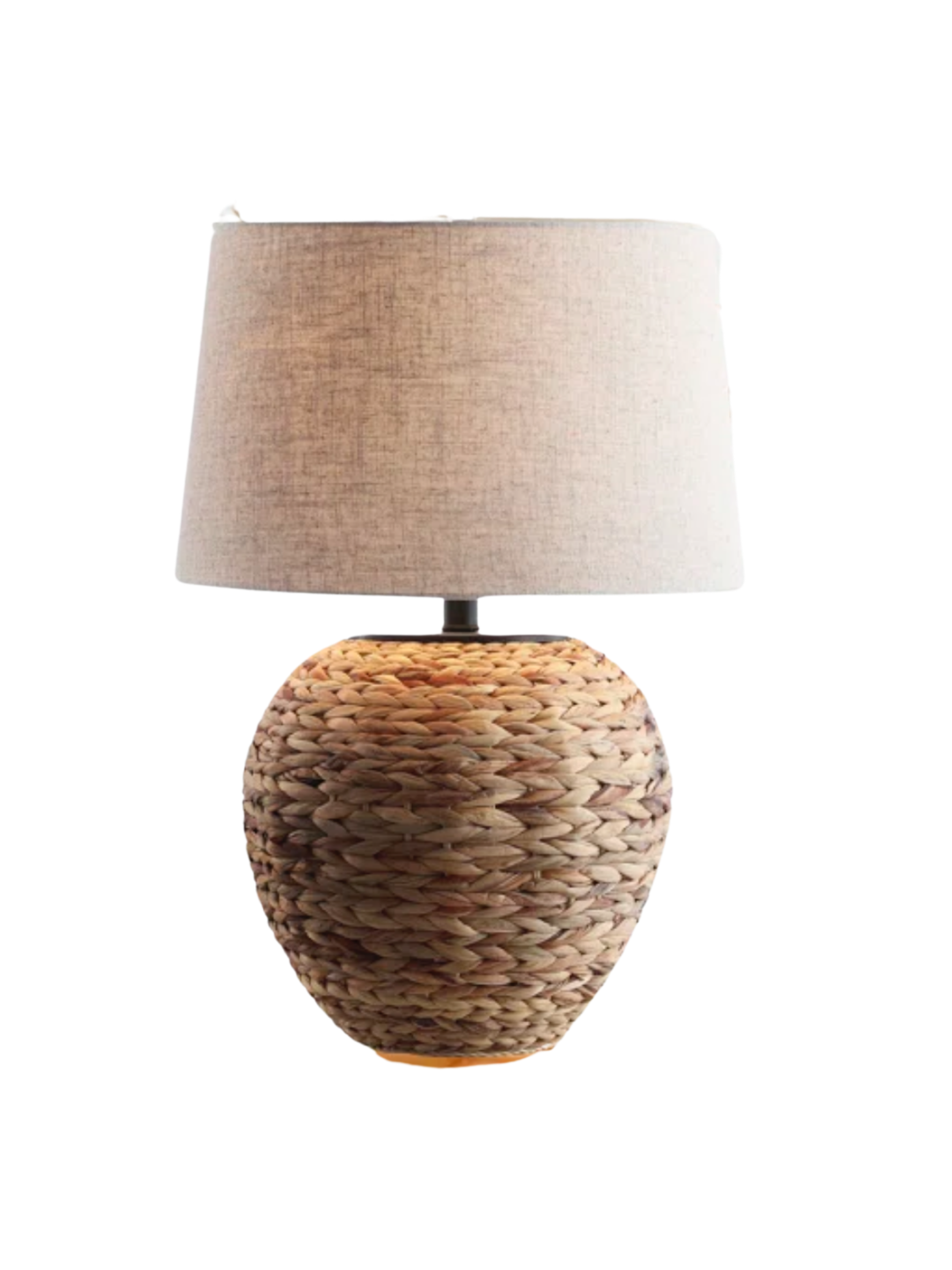 Large natural rattan lamp creating warm ambient light in a bedroom