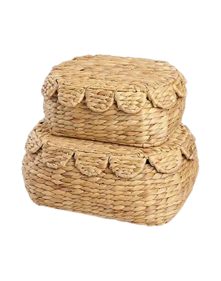 Two woven straw storage baskets, one rectangular and one rounded, with decorative fringes around the top edges.