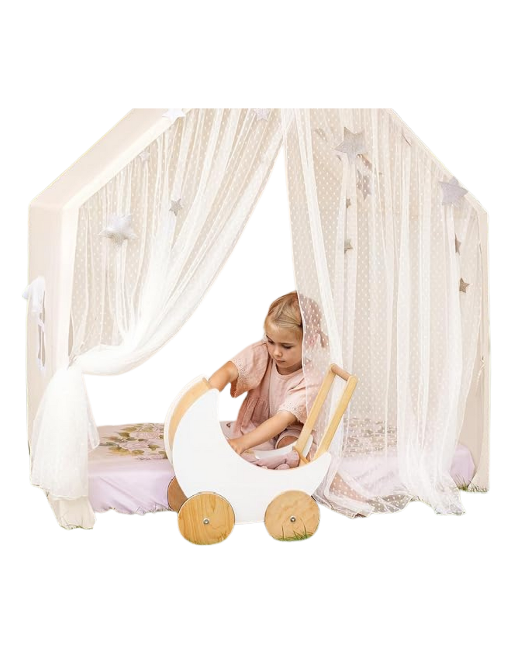 A young girl playing inside a white fabric canopy with star patterns, and wooden wheels, resembling a doll pram, in a cozy space decorated with star-themed curtains.