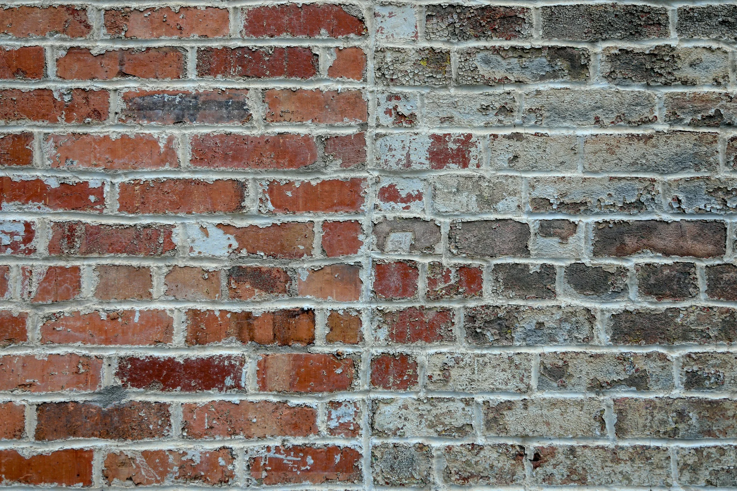 Close-up of aged brickwork and mortar, highlighting defects identified during professional building surveys.