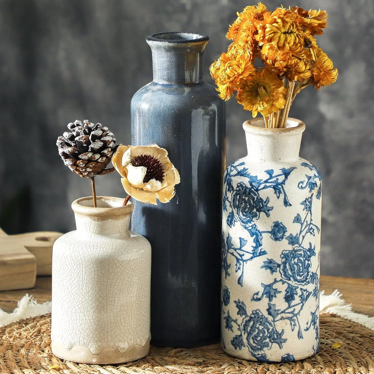 Trio of blue and white vases with dried florals