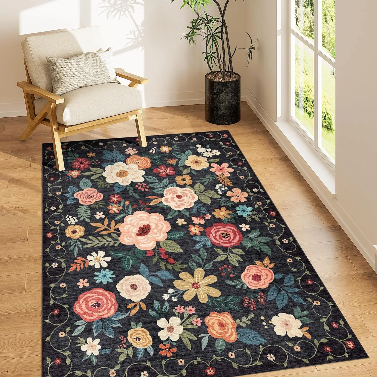 Black rug with multicolor florals in a corner with arm chair and plant