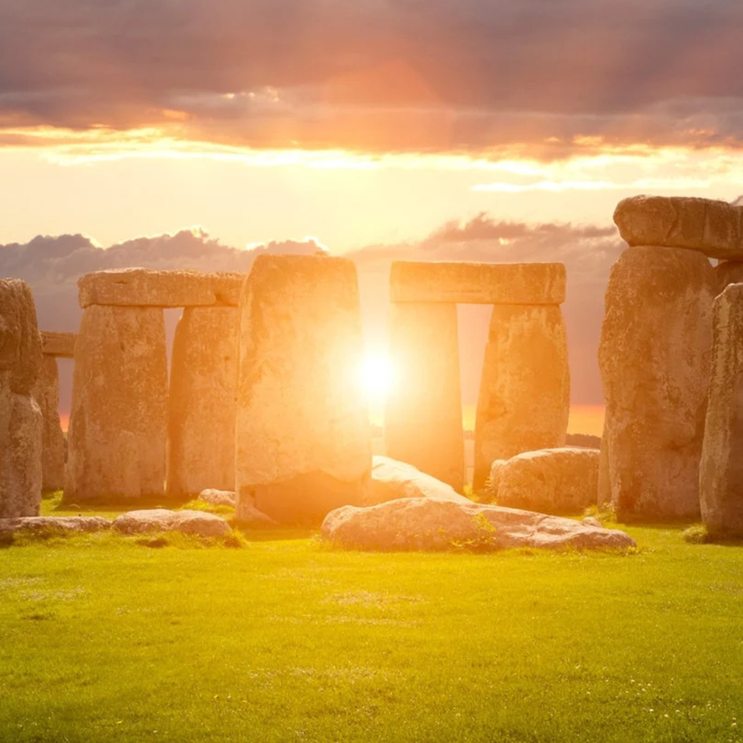 Sunrise shining through Stonehenge during the Summer Solstice, reflecting humanity's long relationship with seasonal cycles and solar observances.