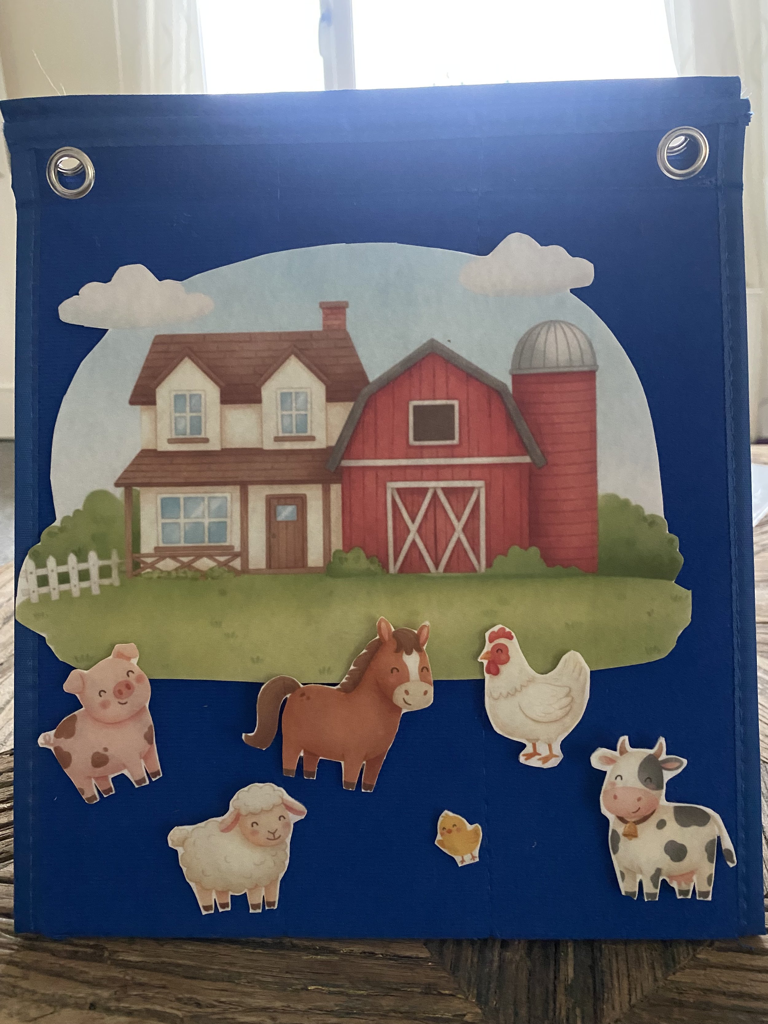 Illustration of a farm house with red barn, silo, and a grassy field with four farm animals: pig, horse, chicken, sheep, and cow.