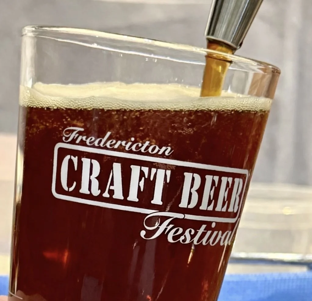 A glass of craft beer being poured at the Fredericton Craft Beer Festival.